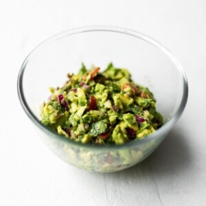 A glass bowl filled with guacamole.