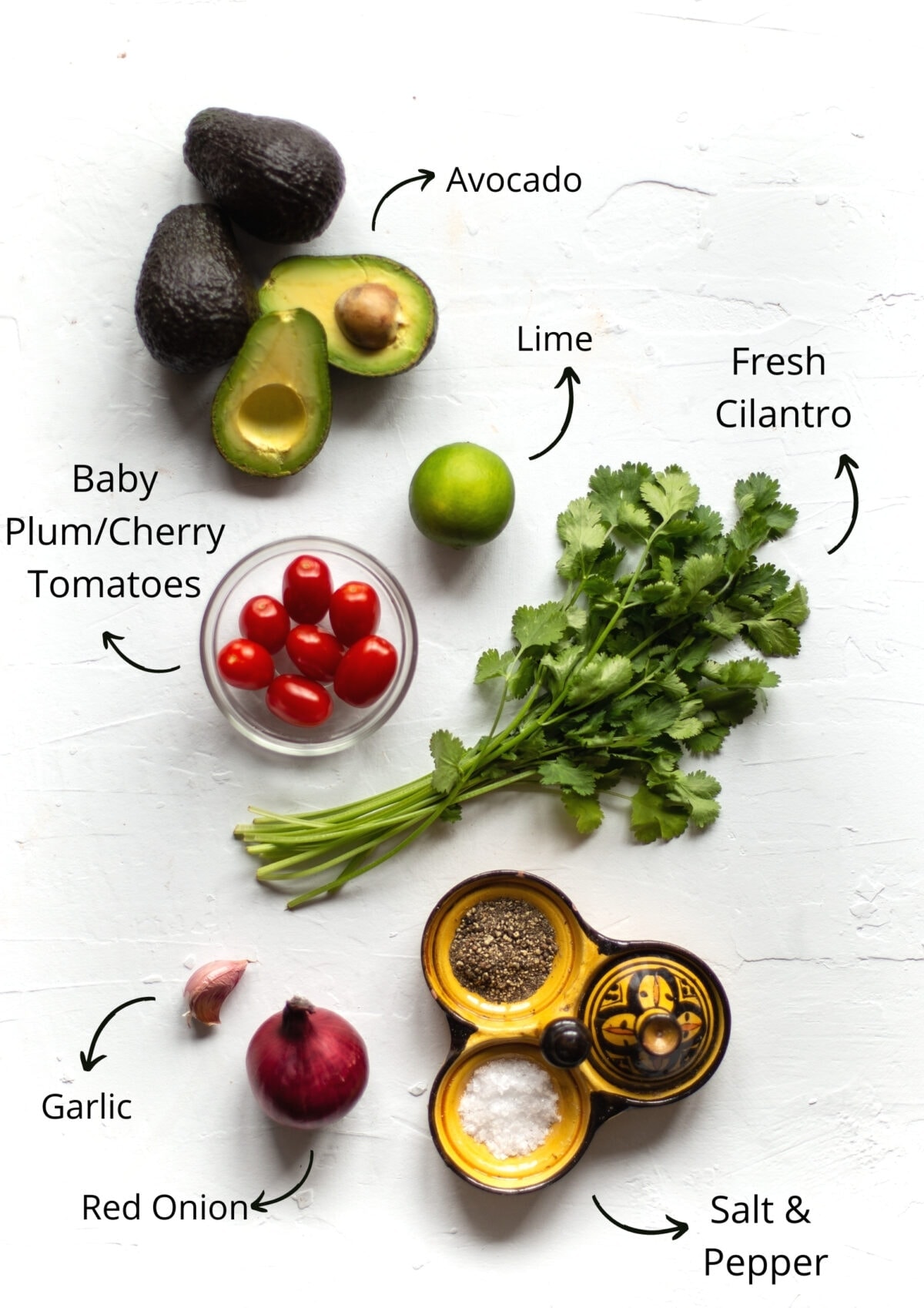 Chunky guacamole Ingredients, laid out on a white board.