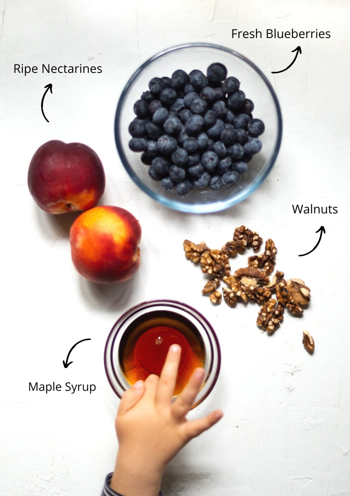 Overhead view of the pancake topping ingredients on a white background.