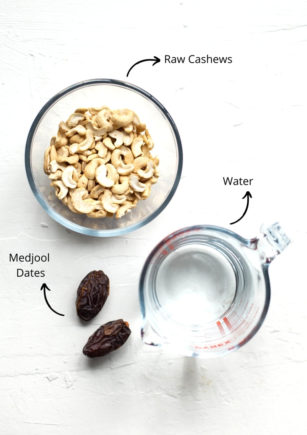Overhead view of cashew cream ingredients on a white background