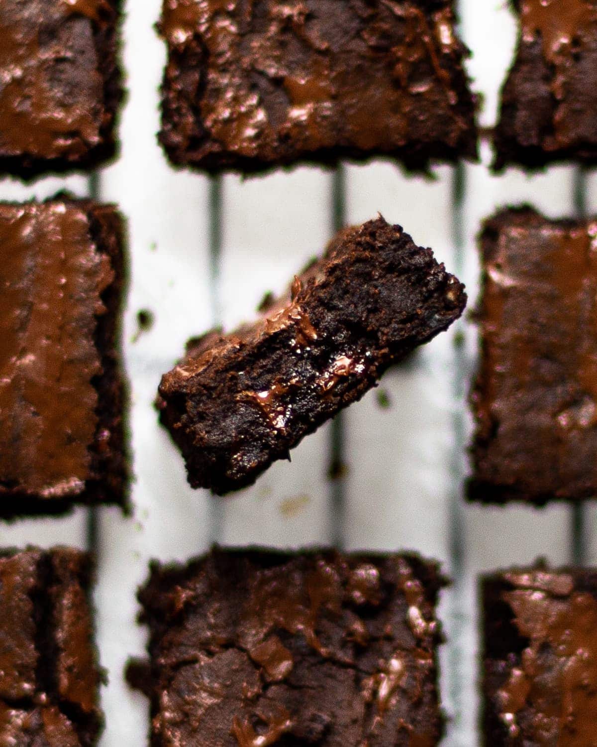 Blackbean brownies on a cooling rack, with one stood on edge.