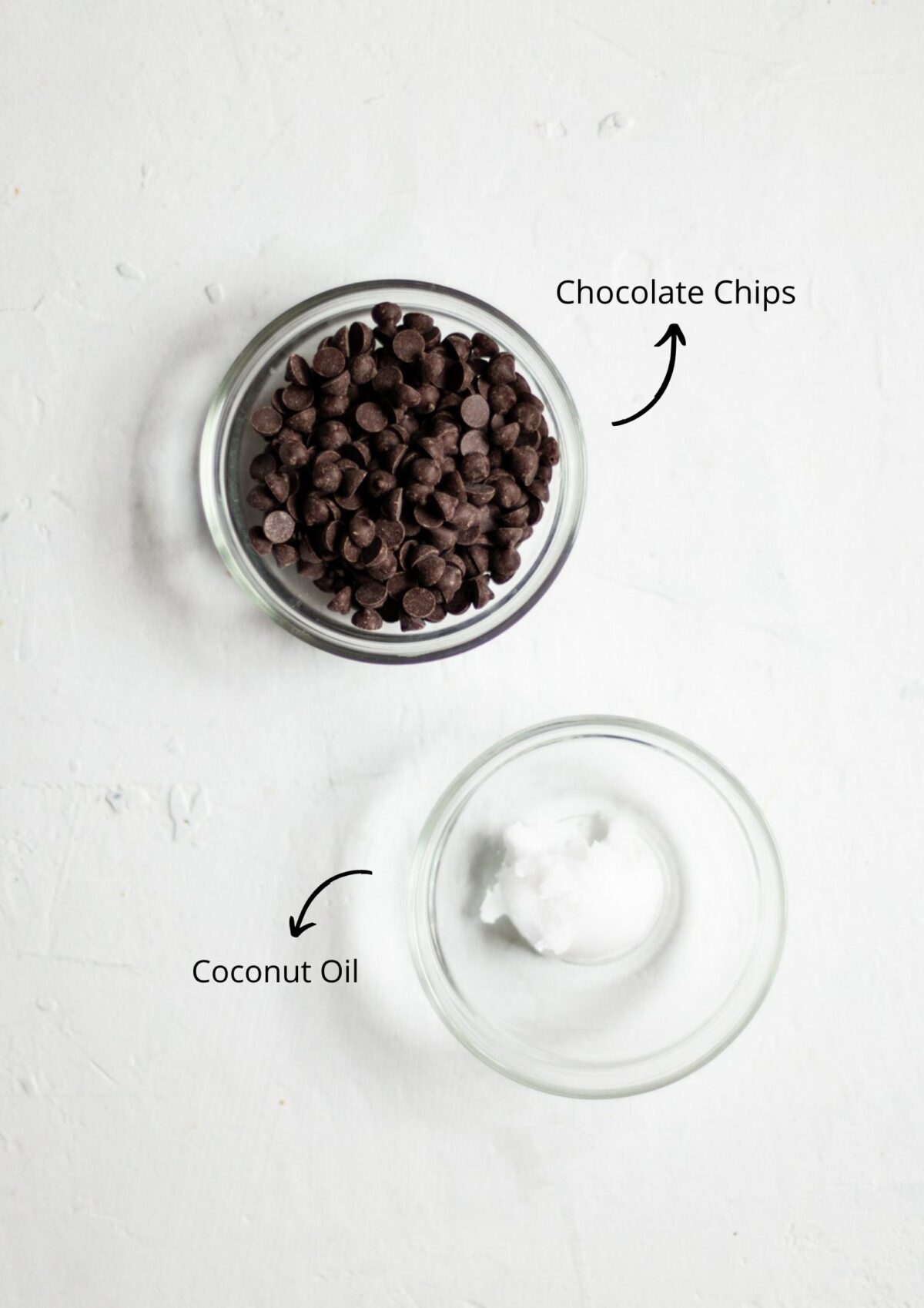 The vegan caramel slice topping ingredients in glass bowls, laid out on a white background.